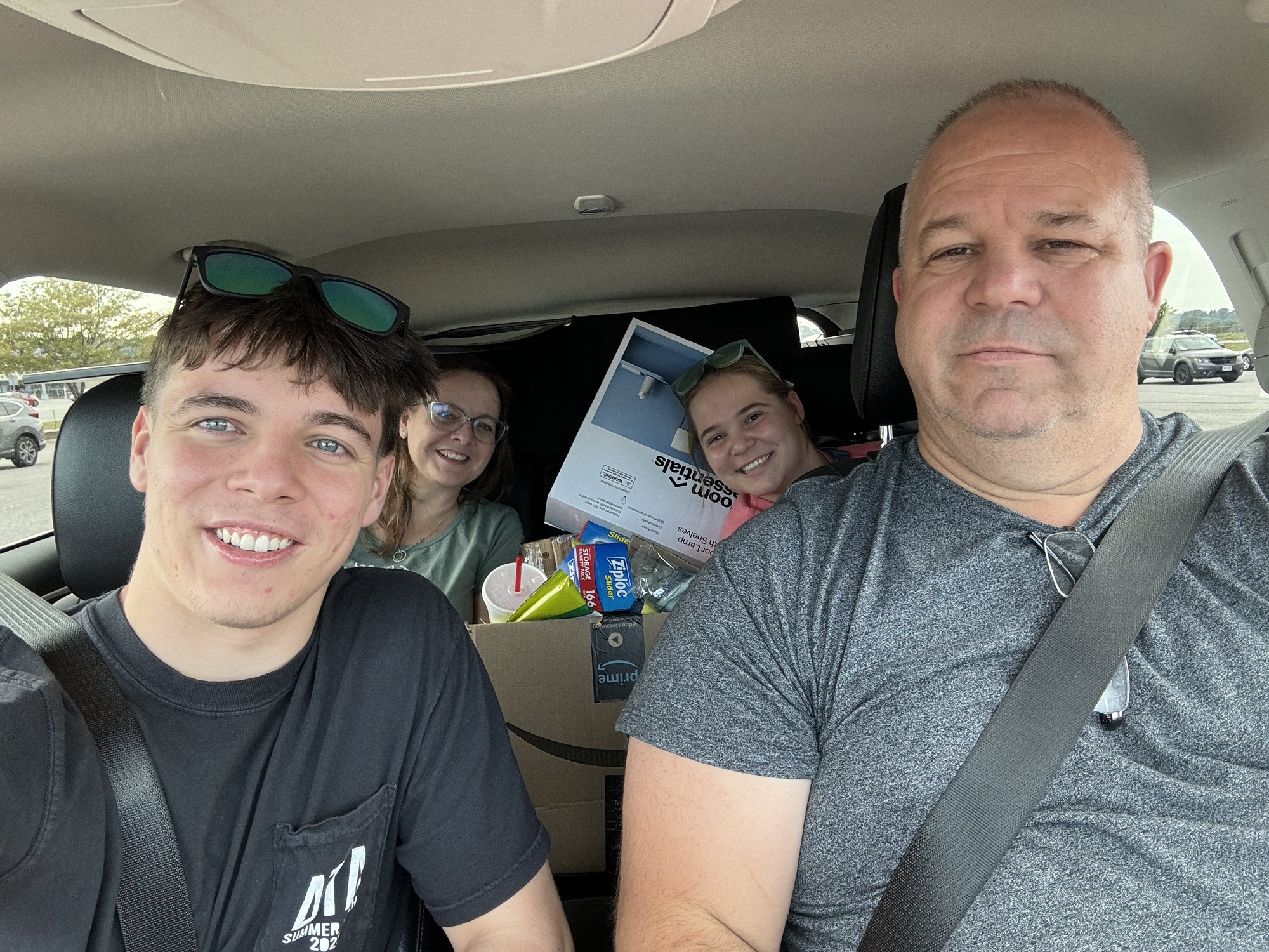 selfie in car filled with college gear